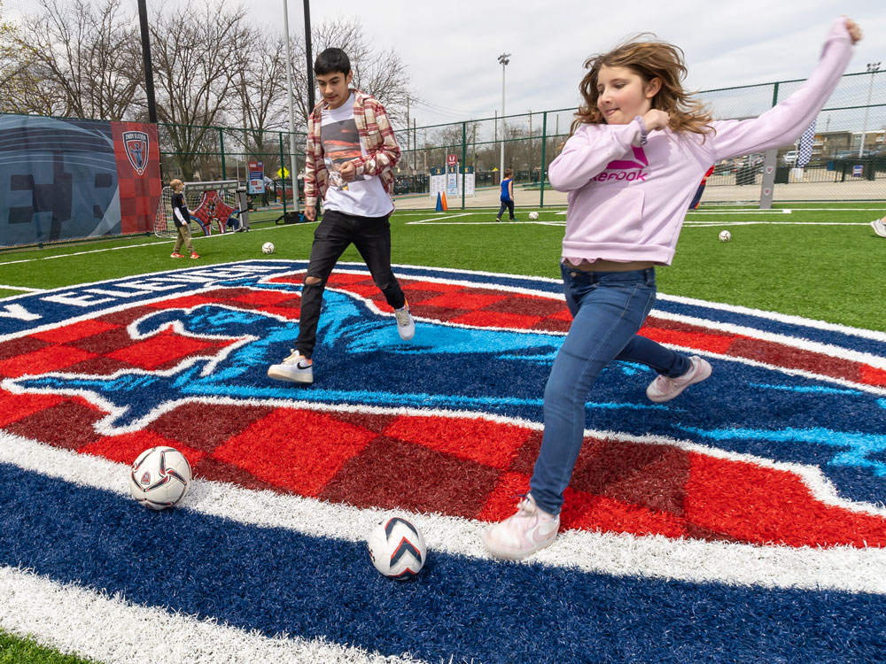 Two children kicking soccer balls in the Indy Eleven Soccer Experience.